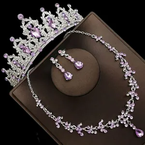 Close-up of bridal jewelry set with purple crystals including tiara, necklace and earrings