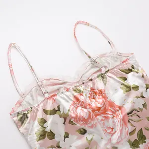 Detailed view of floral satin slip dress featuring white lace trim and slim straps.