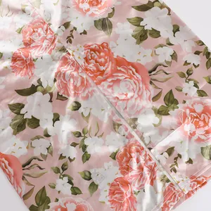 Detailed macro shot of invisible back zipper on a floral print pink satin dress