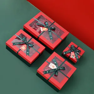 Elegantes cajas de regalo de Navidad con ventana y lazos verde oscuro en rojo y verde