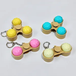 Four styles of bun-shaped light-up fidget spinner keychains with mechanical buttons