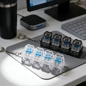Detail view of 4-key mechanical switch fidget keychain with LED light on a desk mousepad