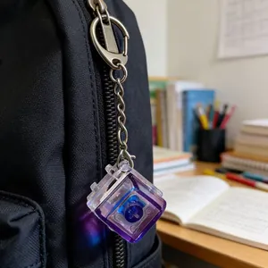 Close-up of a glowing mechanical switch keychain attached to a black backpack zipper