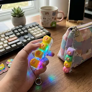 Detailed close-up of a cat paw luminous mechanical fidget keychain toy glowing with RGB lights