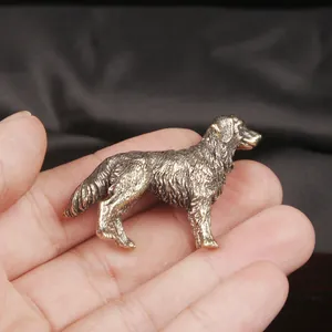 Antique brass golden retriever statue showing detailed engraved fur texture on palm.