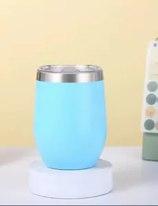 Light blue 12oz insulated stainless steel egg-shaped wine tumbler on a marble pedestal