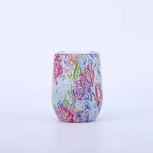 Detailed view of a 12oz stainless steel insulated tumbler with vibrant colorful coral patterns