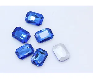 Close-up of octagonal blue glass rhinestones with pointed silver back for DIY crafts