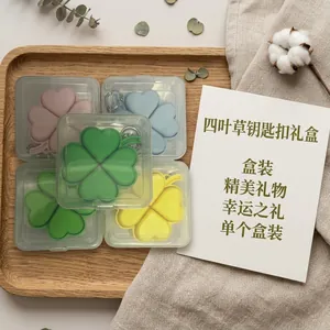 Detailed macro view of colorful glowing four-leaf clover stress relief keychains in gift boxes