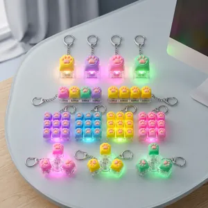 Collection of colorful LED macaron cat paw fidget keychains for stress relief.