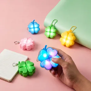 Glowing four-leaf clover fidget keychain with mechanical switch for stress relief