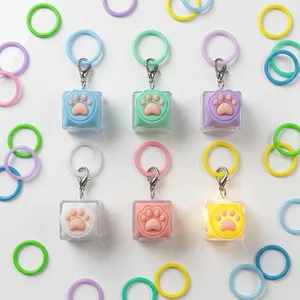 Macro view of macaron-colored cat paw glowing keychains in six different colors