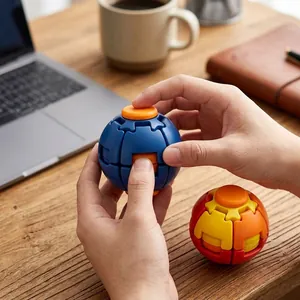 Close-up view of a 3D printed rotating decompression ball being held and manipulated.