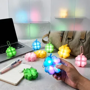 Glowing four-leaf clover fidget keychain toy with mechanical switch feel and colorful light