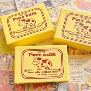 Detail of yellow butter squishy toy with Pure milk cow label for stress relief
