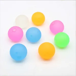Colorful translucent maltose squishy stress balls scattered on a white background