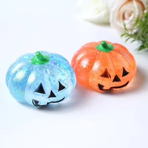 Detailed macro view of blue and orange glittery Halloween pumpkin stress relief toys
