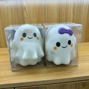 Close-up view of cute mini Halloween ghost squishy toys in transparent plastic box packaging