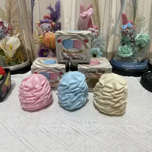 Detailed close-up view of three colorful cream-swirl squishy toys with packaging boxes