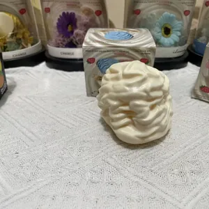 Macro detail view of white whipped cream squishy toy with its colorful packaging box