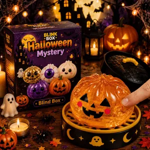 Close-up detail of the glowing orange Halloween pumpkin squeeze toy and packaging.