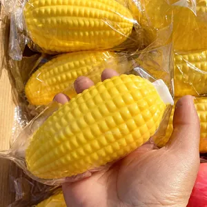 Close-up detail of a hand squeezing a realistic yellow corn toy for stress relief therapy