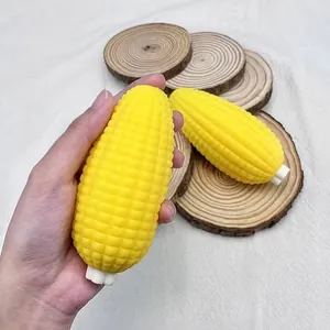 Macro detail of simulation yellow corn cob squishy toy being held to show texture