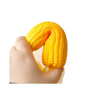 Soft and elastic simulation corn cob squishy toy being squeezed for stress relief.