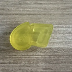Close-up of translucent yellow '67' shaped TPR squeeze toy for stress relief