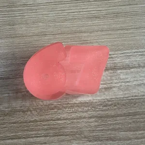 Macro view of a pink translucent glittery '67' shaped TPR squishy decompression toy