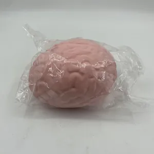 Close-up detail of a pink brain-shaped slow rebound squishy stress ball in clear packaging