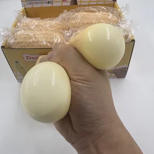 Detailed macro view showing a hand squeezing a soft realistic peanut stress relief toy