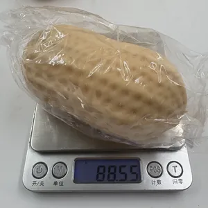 Realistic peanut-shaped squishy toy showing a weight of 88.55g on a digital scale