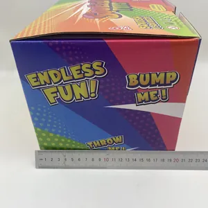 Detailed view of the colorful squeeze toy packaging box with a metal ruler for size reference.