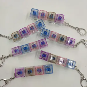 Porte-clés mécaniques à 4 touches colorés avec capuchons transparents pour le stress.