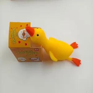 Gelbe Enten-Quetschi-Spielzeug springt aus seiner orangefarbenen Verpackung.