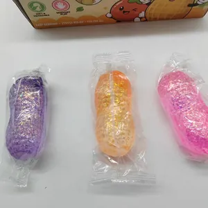Glitter peanut-shaped squishy toys in purple, orange, and pink individual packaging