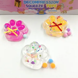 Detailed view of three cat paw maltose squeeze toys with glitter and colorful ribbon bows