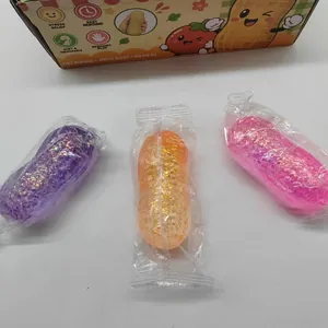 Close-up of three peanut-shaped slow rebound squishy toys in purple, orange and pink