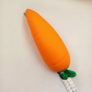 Macro view of a realistic carrot squishy toy placed on a metal ruler for scale