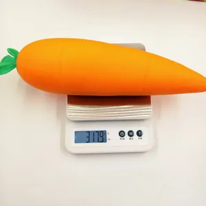 Large carrot-shaped flour-filled squeeze toy weighing 317.9g on a digital scale