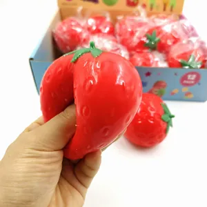 Close-up showing the soft texture and squeeze action of a strawberry stress relief toy