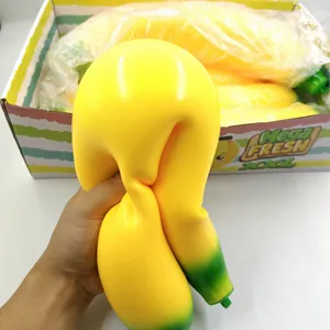 Close-up of a large yellow banana squishy toy being squeezed to show its soft texture