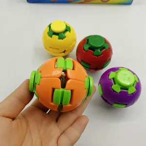 Detail shot of a hand holding a colorful rotating puzzle fidget ball toy for stress relief