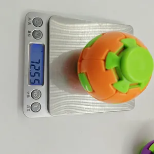 Top view of colorful decompression toy ball on digital scale showing weight of 72.5g