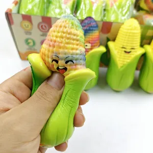 Rainbow corn squishy toy being squeezed to show slow rebound PU stress relief texture.