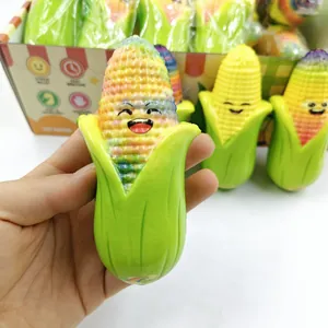 Macro view of hand holding a colorful rainbow corn squishy toy for stress relief