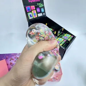 Gros plan détaillé d'une main pressant un jouet anti-stress transparent aux fruits