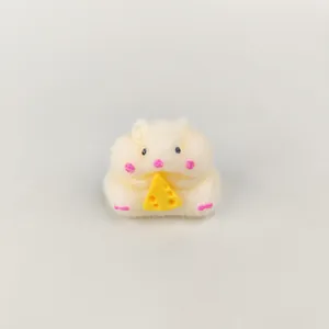 Detailed view of a soft plush hamster squishy toy holding a yellow cheese wedge