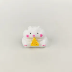 Detailed macro view of a cute fluffy hamster squishy toy holding a piece of cheese